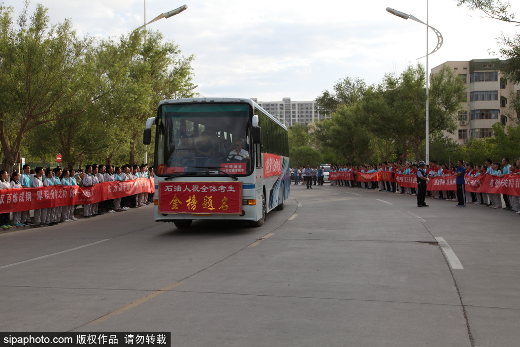 新疆哈密：高考第一日 低年級學(xué)生家長送考沿路壯行